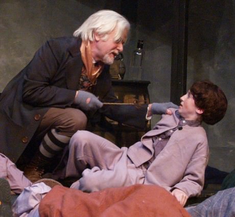  Fagin (Michael Hulet) asks Oliver (Samantha Bloom Yakaitis) how much he saw of Fagin’s valuables. Photo by Steve Teller.